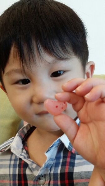 Jerry holding a heart shaped jelly bean