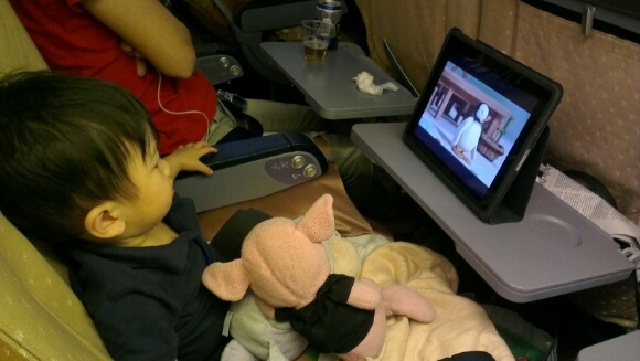 Jerry watching cartoon on ipad on the flight back from our Hong Kong vacation